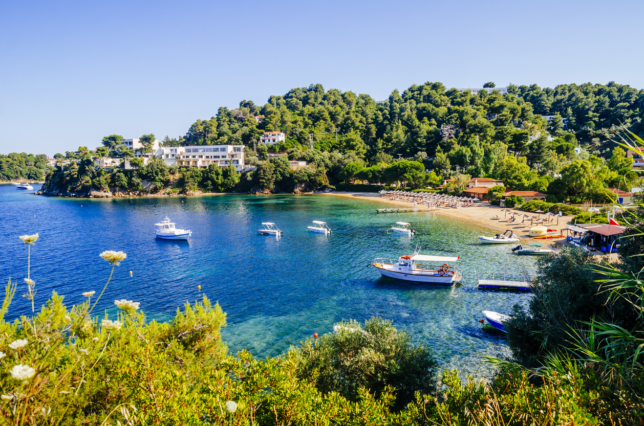Troulos beach, Skiathos island, Greece. Beautiful vivid panorama view of blue aegean sea coast from wild cliff. Summer holiday vacation tour to greek islands.