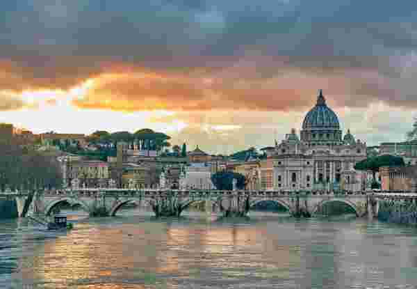 Rome with St. Peter's cathedral and Tiber river at evening in Rome