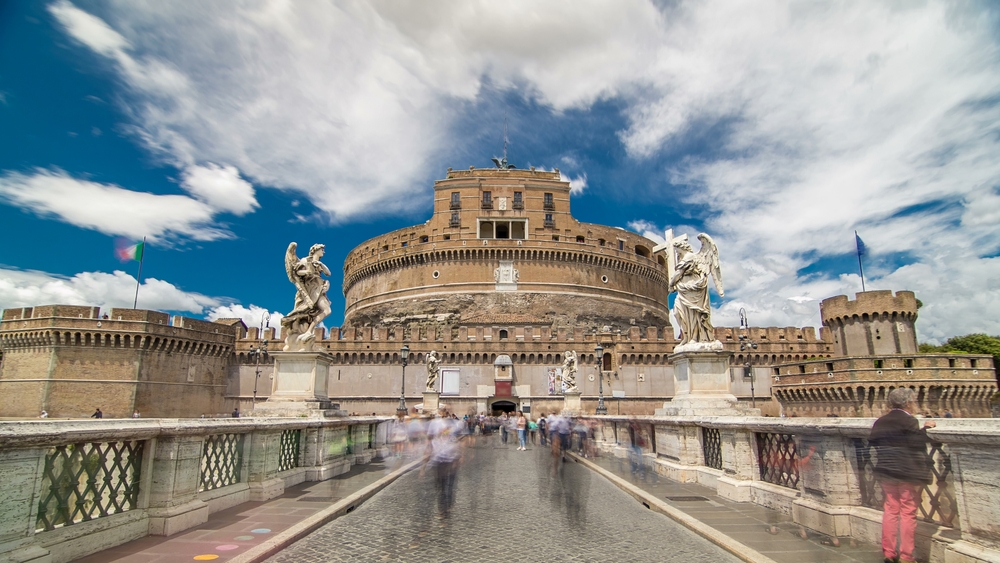 Castel Sant’Angelo and Ponte Sant’Angelo with visitors crossing the bridge in central Rome.