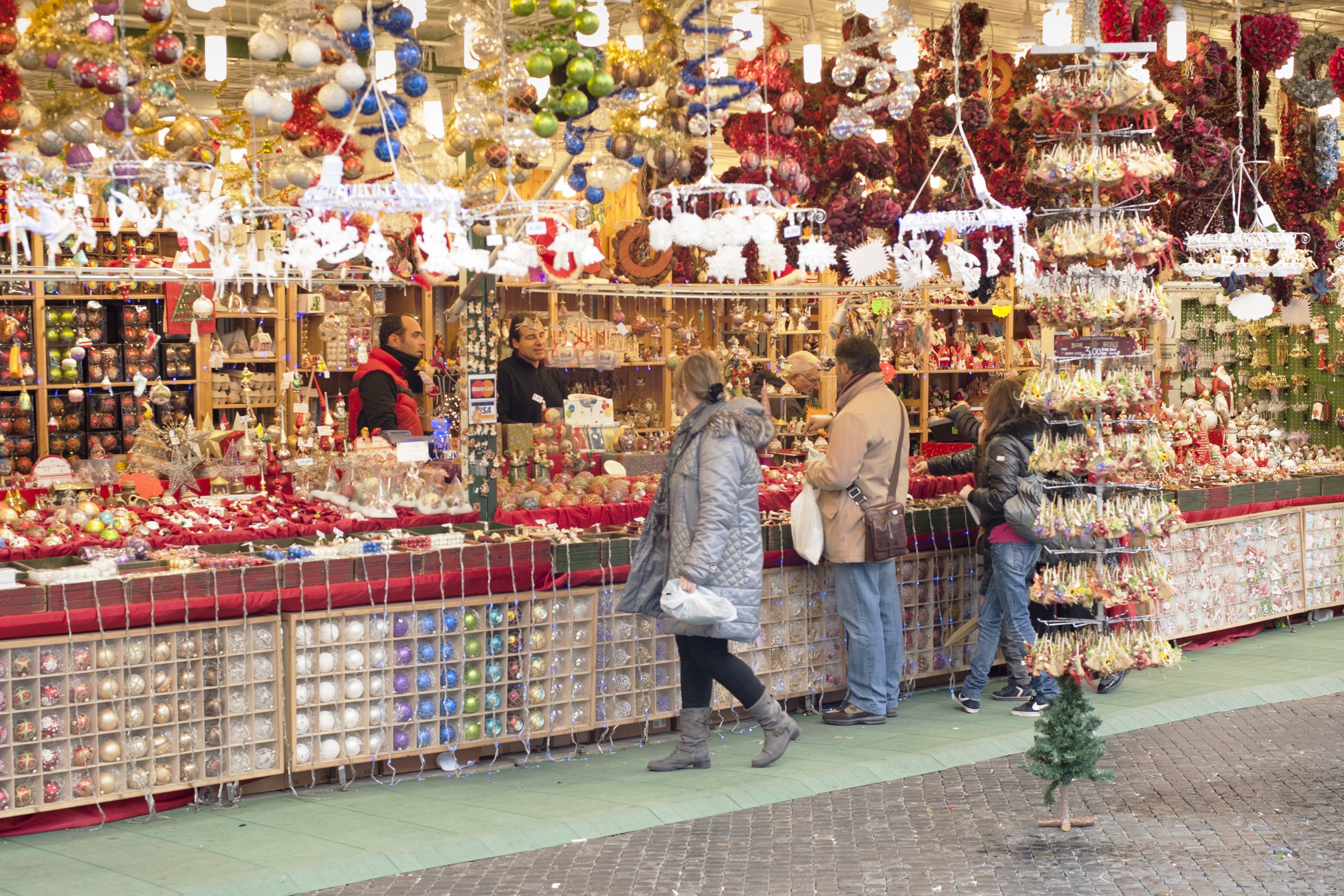 Sellers and buyers in a stall in Piazza Navona in Rome sell a classical Christmas object.