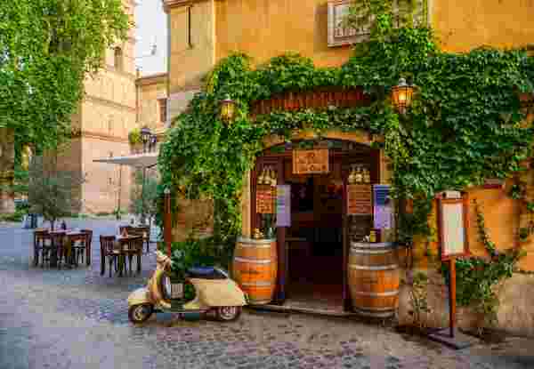A lovely vintage Vespa outside a typical restaurant in the Trastevere district in the historic heart of Rome