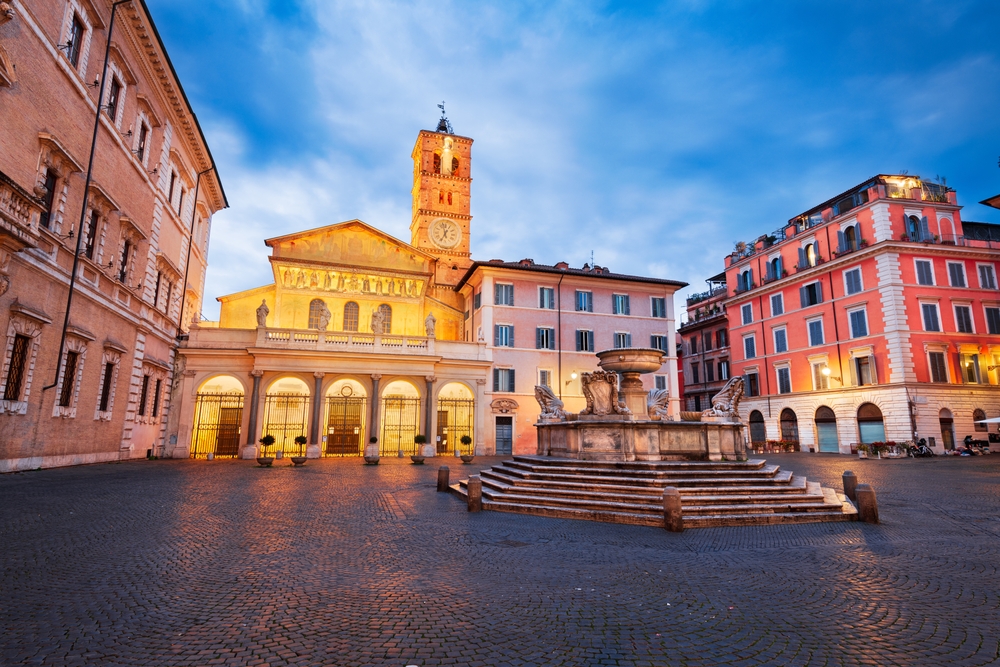 Evening view of Basilica of Santa Maria in Trastevere and its fountain in one of Rome’s most charming squares
