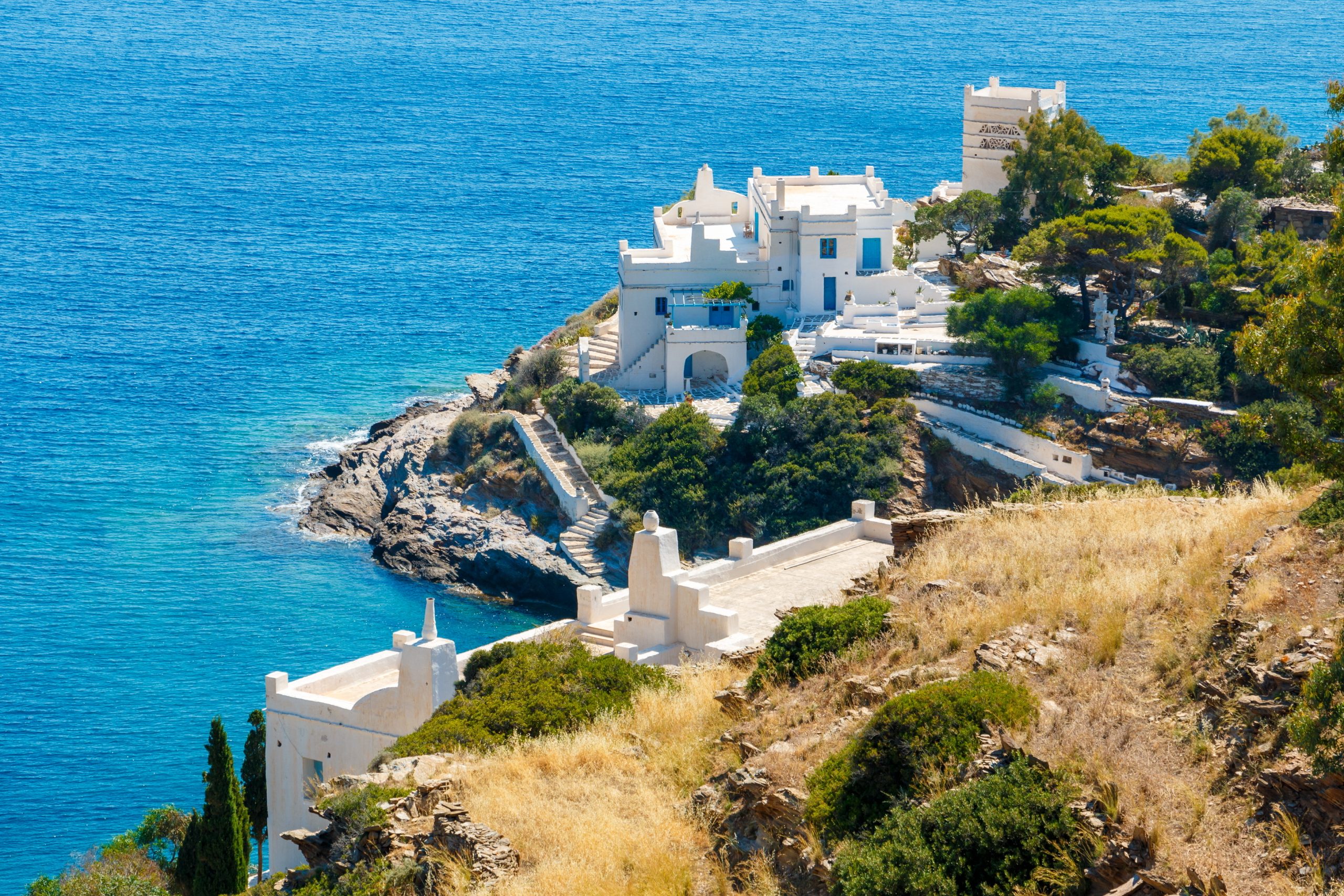 White hotels on the blue sea side on Ios island, Greece