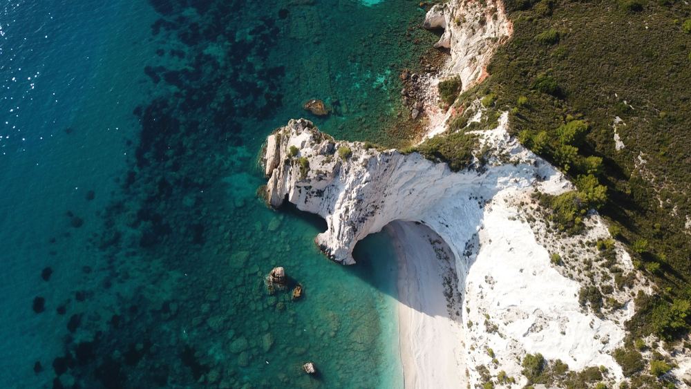 Aerial drone photo of iconic white rock cliffs and volcanic formations near famous beach of Platys and Makrys gialos with turquoise clear sea, Argostoli, Kefalonia island, Ionian, Greece