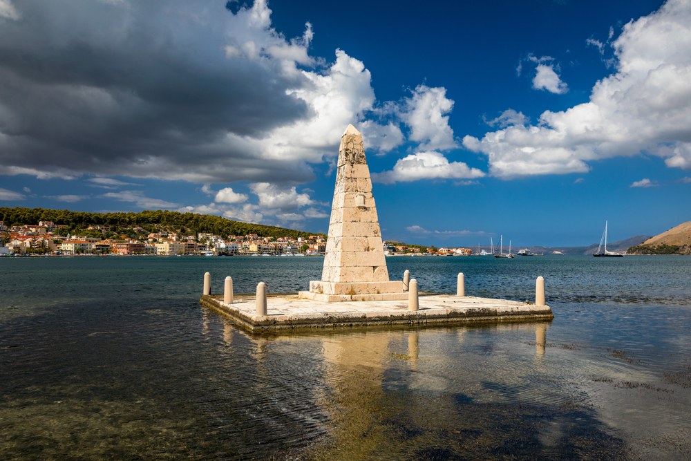 View of the De Bosset Bridge in Argostoli city on Kefalonia island. De Bosset Bridge on lakeside In Argostoli, Kefalonia. Obelisk and the de Bosset bridge in Argostoli, Kefalonia, Greece
