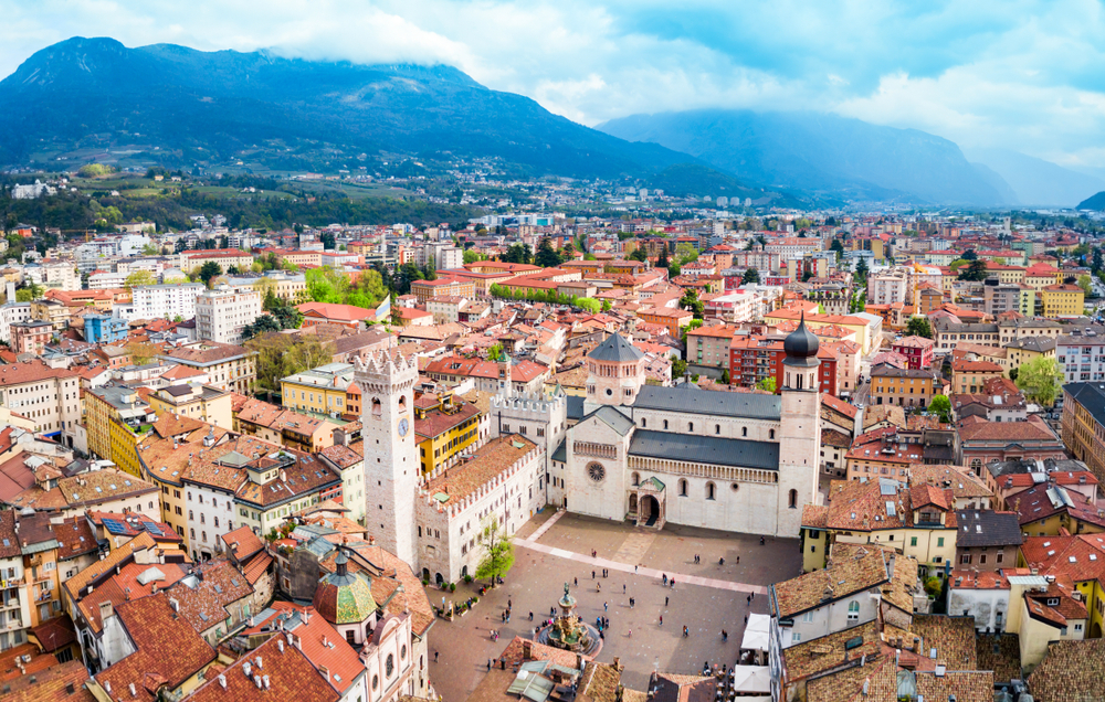 Aerial view of Trento city centre with Trento Cathedral and surrounding mountains in northern Italy
