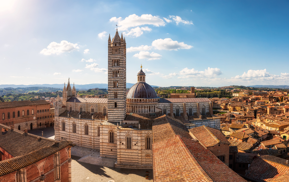 Siena Cathedral and historic centre viewed from above with medieval architecture and terracotta rooftops