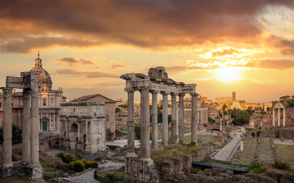 Ancient ruins of the Roman Forum at sunset with historic columns and archaeological remains in central Rome