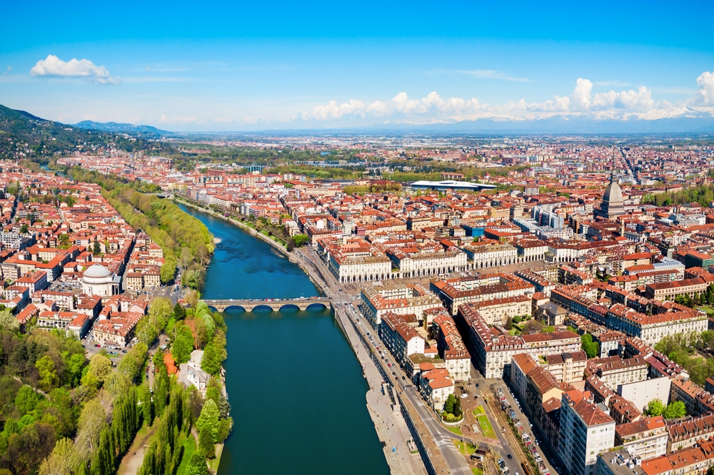 Aerial panorama of Turin with the Po River, historic architecture and the Alps in the distance