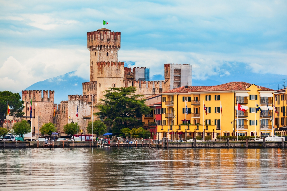 Scaliger Castle in Sirmione on Lake Garda with historic fortifications reflected in calm waters