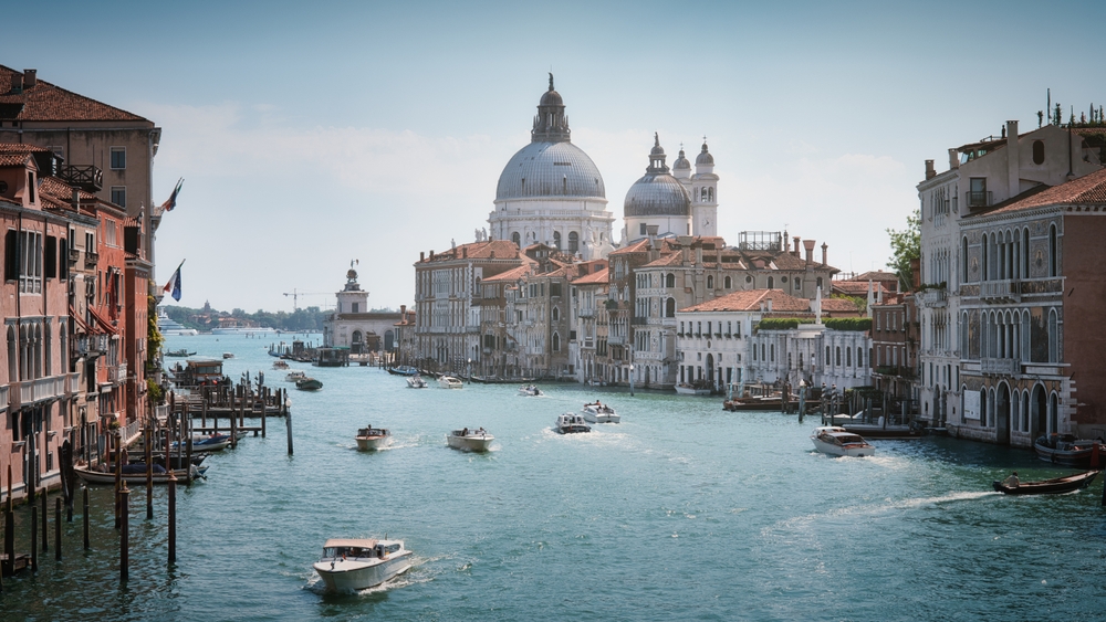 Venice Grand Canal with Basilica di Santa Maria della Salute and traditional Venetian palaces lining the waterfront
