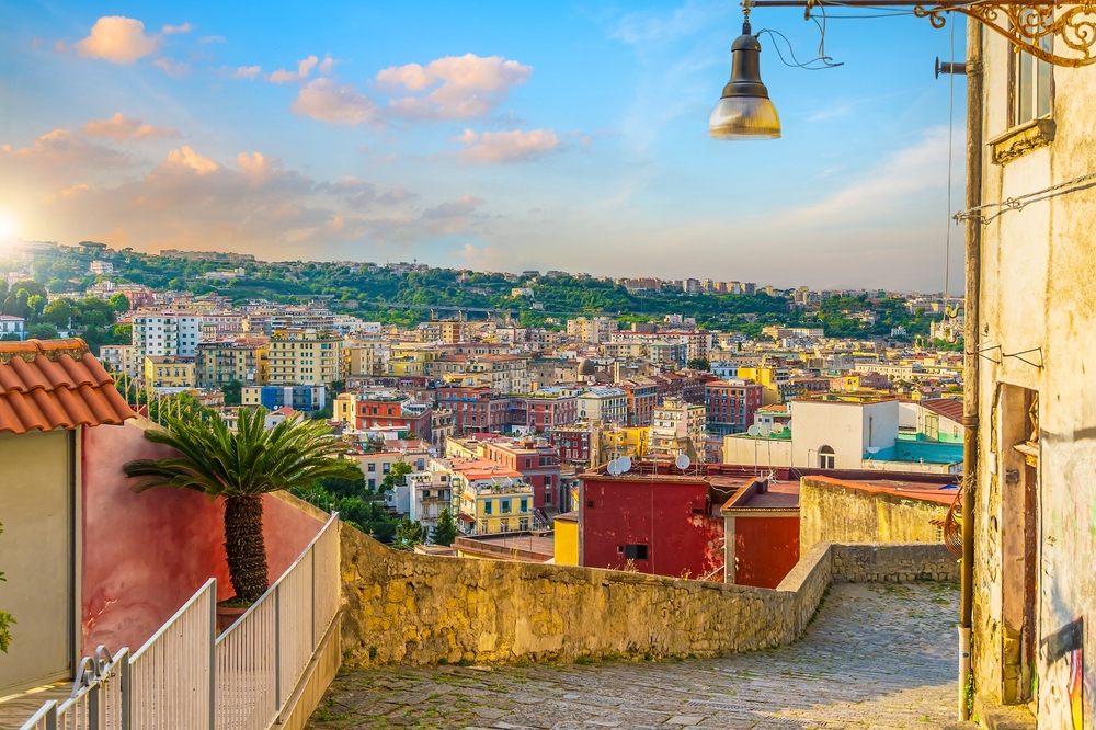 Colorful hillside neighbourhood overlooking Naples with views across the city at sunset