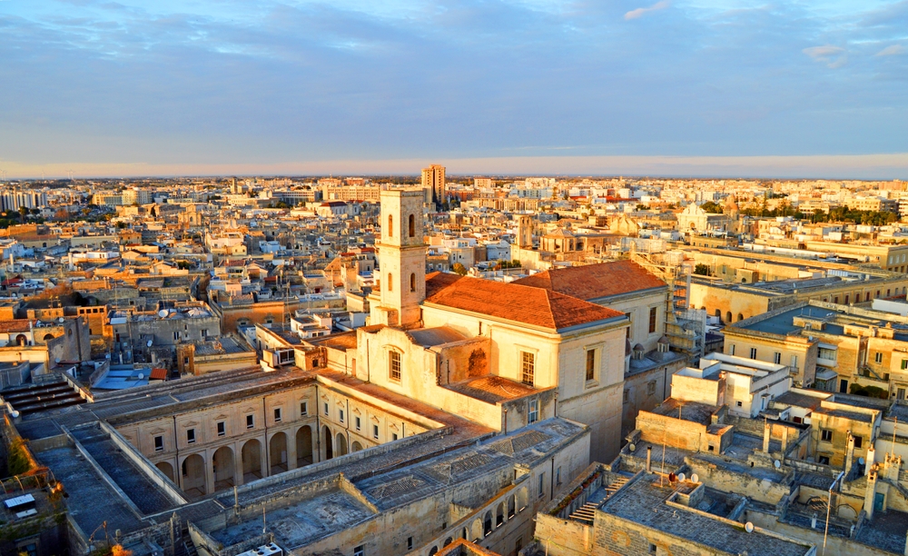 Aerial view of Lecce’s historic centre with Baroque architecture bathed in golden evening light