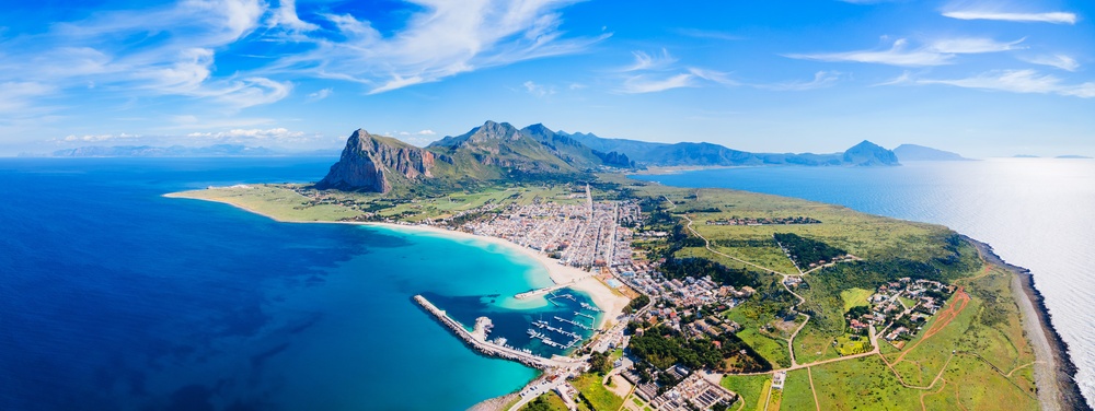 Aerial view of San Vito Lo Capo in Sicily with turquoise waters, sandy beaches and Monte Monaco in the background