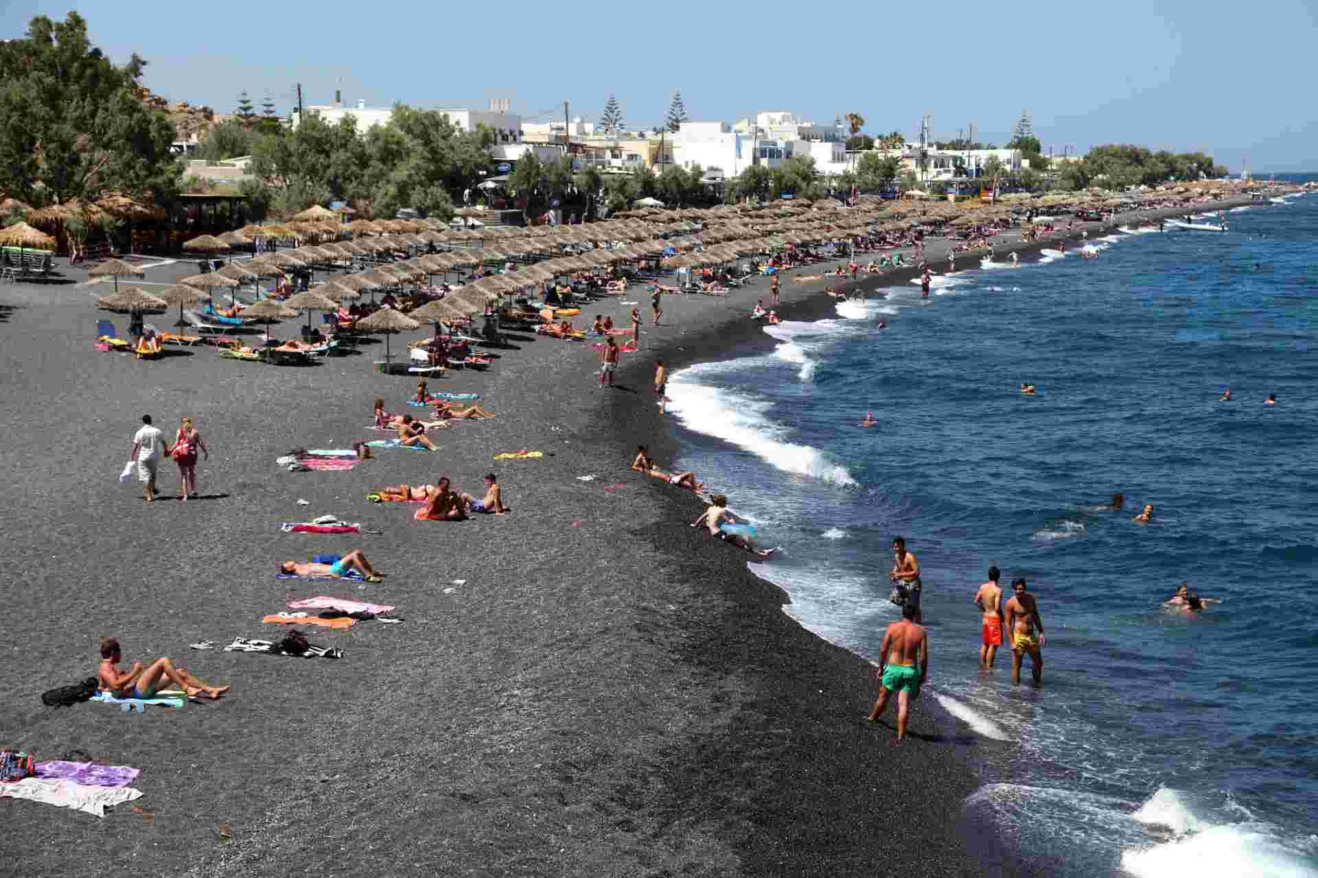 Santorini,,Greece,-,June,30:,People,Sunbathing,And,Swimming,At