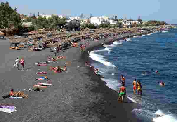 Santorini,,Greece,-,June,30:,People,Sunbathing,And,Swimming,At