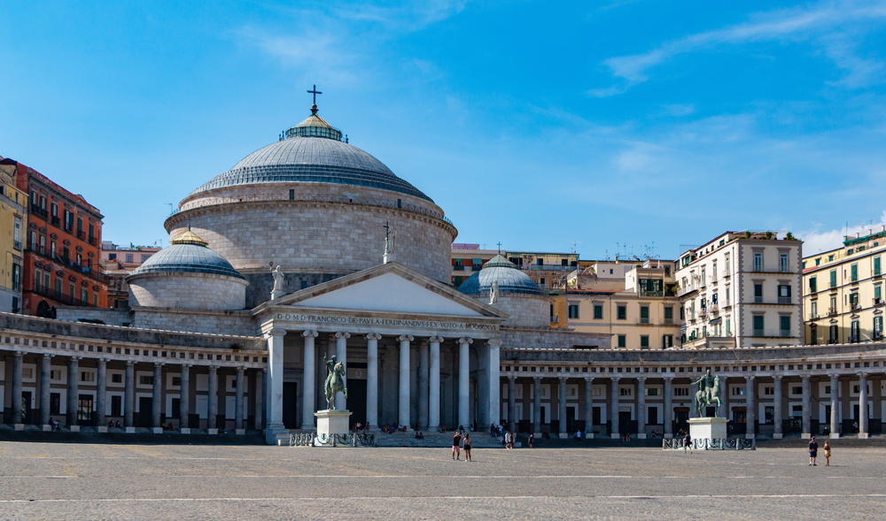 Panoramic view of Piazza del Plebiscito and the Basilica of San Francesco di Paola in Naples under a clear blue sky 