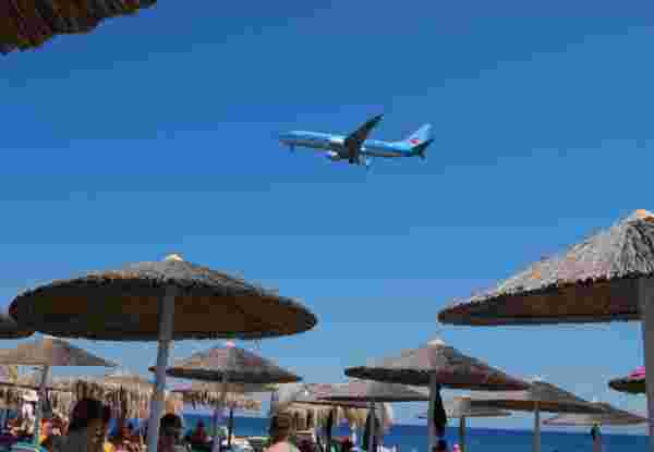Santorini Greece September 2017, Airplan flying low over a beach with people at Kamari beach Santorini,Greece,September,2017,,Airplan,Flying,Low,Over,A,Beach