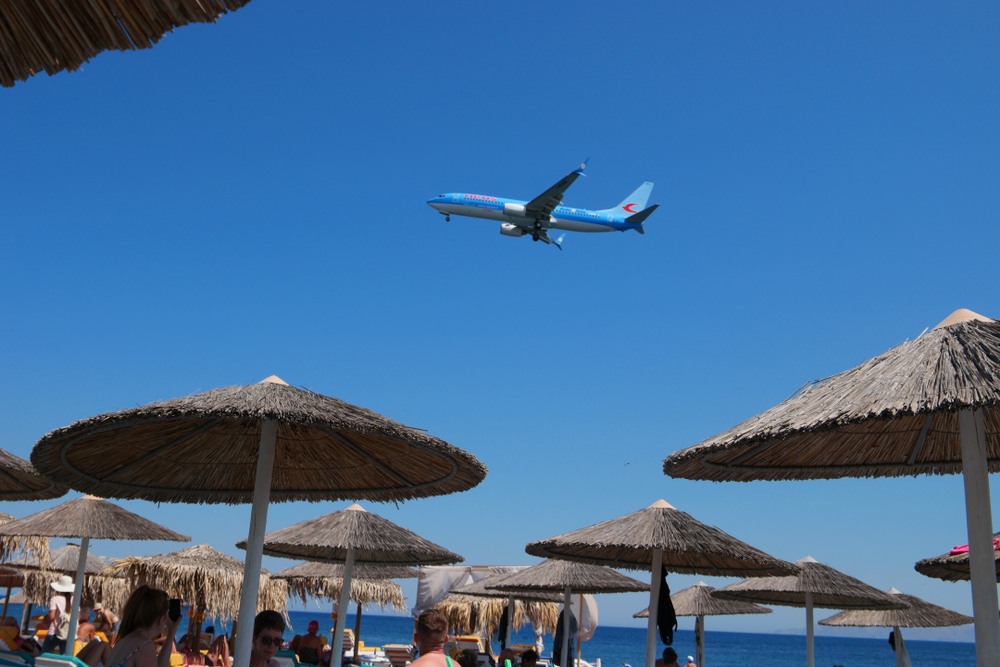 Santorini Greece September 2017, Airplan flying low over a beach with people at Kamari beach Santorini,Greece,September,2017,,Airplan,Flying,Low,Over,A,Beach